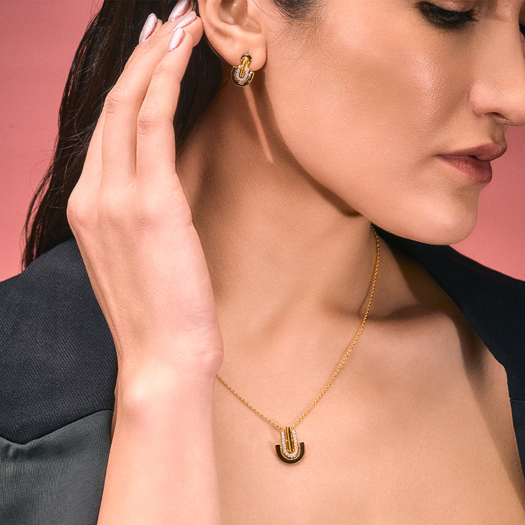 An image containing Sleek Black Enamel and Shimmering Cubic Zircons Pendant & Earrings with 10gm Silver Coin MMTC PAMP Gift Hamper.
