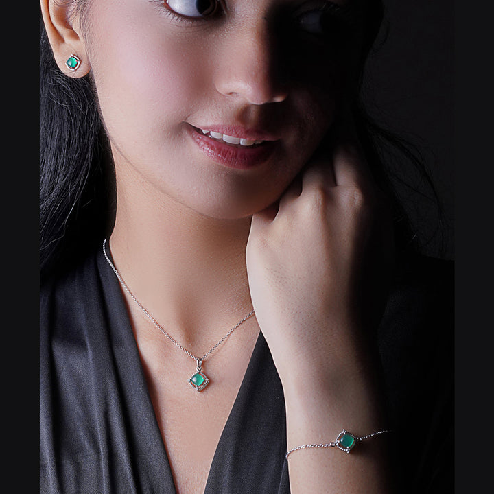 An image of Nature's Splendor Green Onyx Sugar Loaf Cubic Zirconia Earring, Bracelet & Pendant with Silver Chain & 10gm Silver Coin MMTC PAMP Gift Hamper.