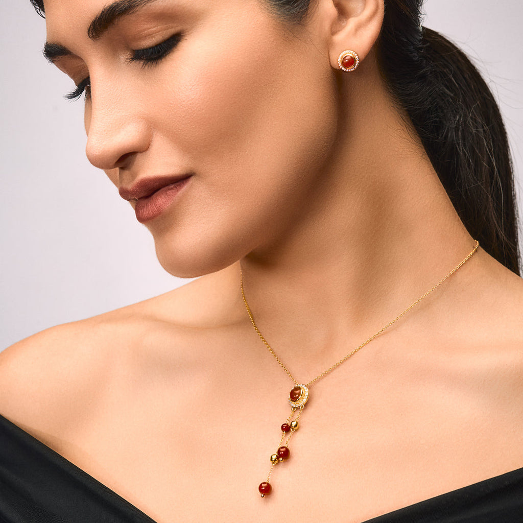 An image of Scarlet Sparkle Suite Red Onyx and Zircon Earring, Pendant, Bracelet with Golden Chain & 10gm Silver Bar MMTC PAMP Gift Hamper.