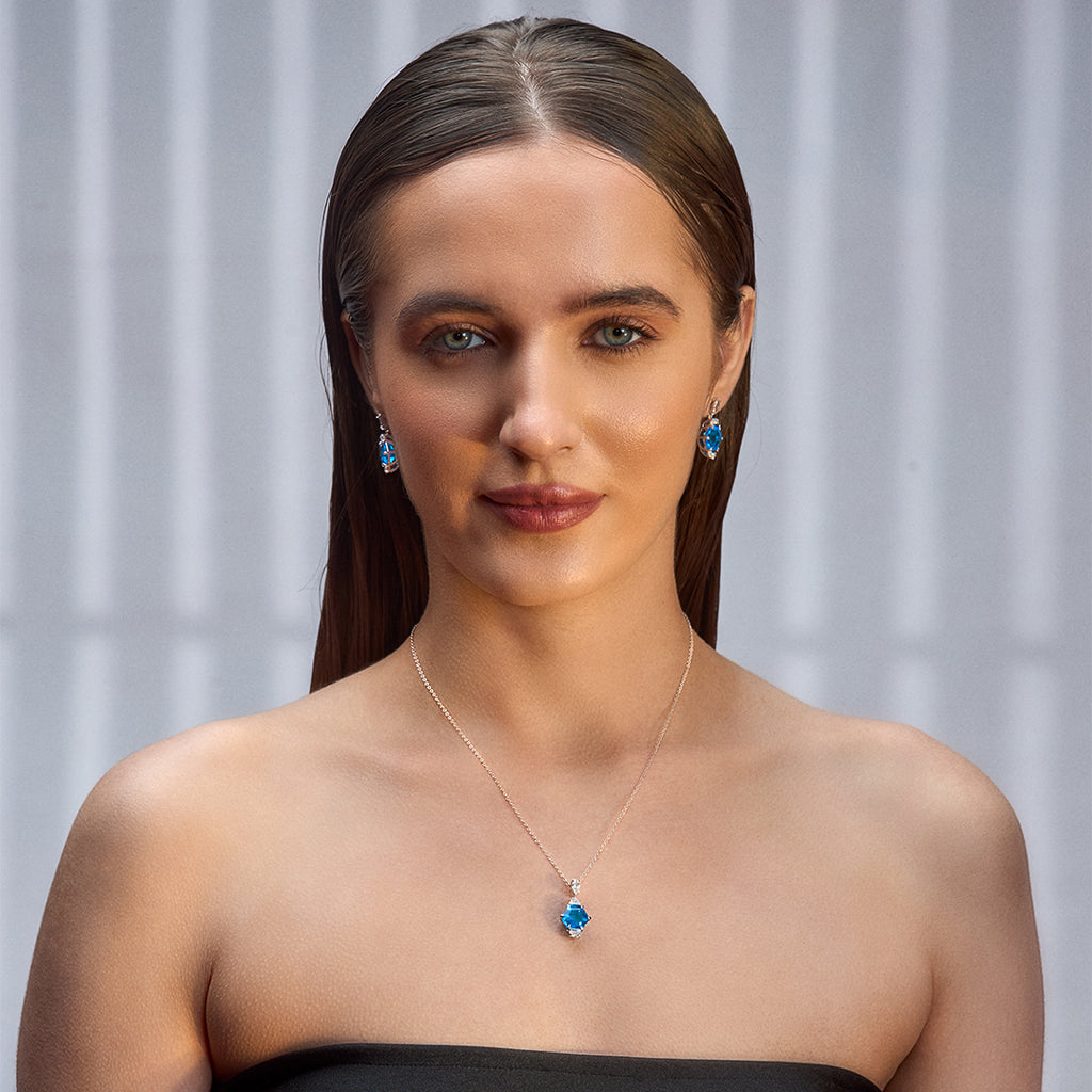 An image of Radiant Swiss Blue Gem Earrings, Pendant, Silver Chain With 10gm Silver Bar MMTC PAMP Gift Hamper.