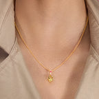 A woman wearing a Pendant with Cubic Zirconia in Lemon and Pink Colour.