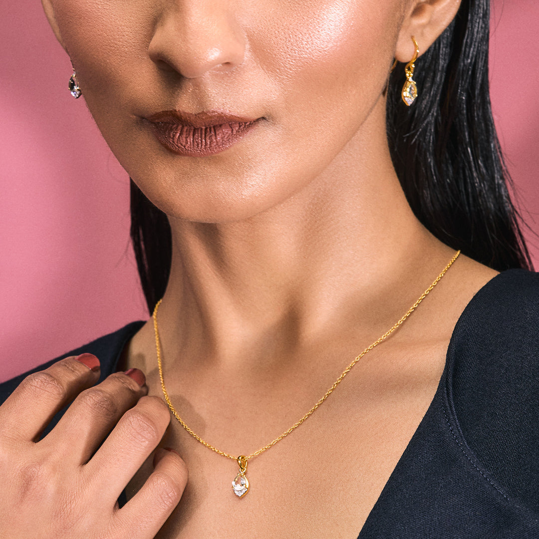 A woman wearing a Pendant with Silver Chain which is Gold-Finished with Green Amethyst and Cubic Zirconia.