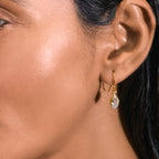 A woman wearing a Gold-Finished Earring with Green Amethyst and Cubic Zirconia.