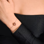 A woman wearing a Silver Bracelet featured with Red Garnet and Cubic Zirconia.