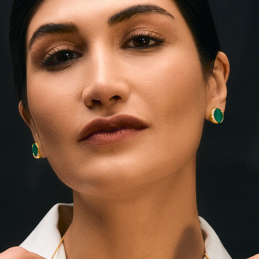 A woman wearing a Glamorous Green Malachite Earring with Cubic Zirconia, Luxe Gold Finishing.