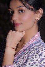 A woman wearing Red Colored Bracelet featuring Cubic Zirconia.