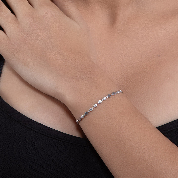 A woman wearing Elegant Silver Finish Tennis Bracelet with Diamond Accents.