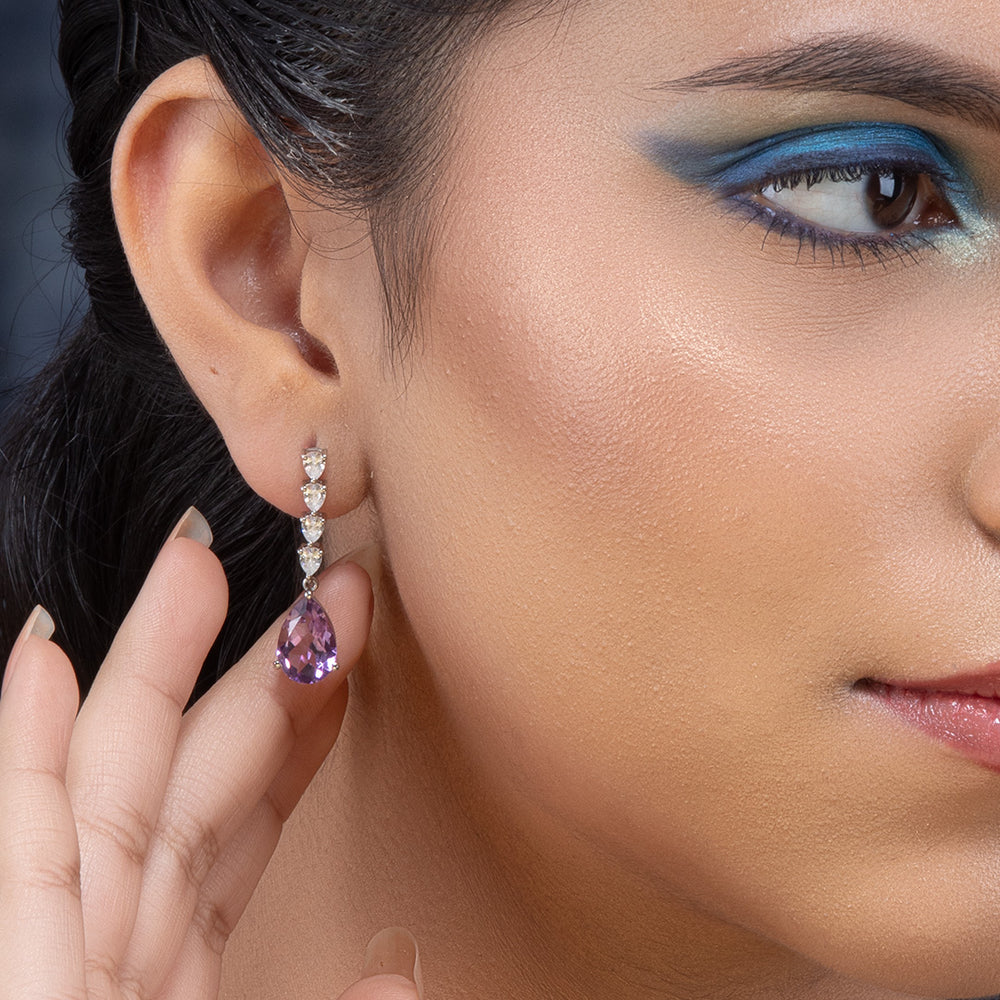 A woman wearing Purple Amethyst Elegance Silver Earrings.