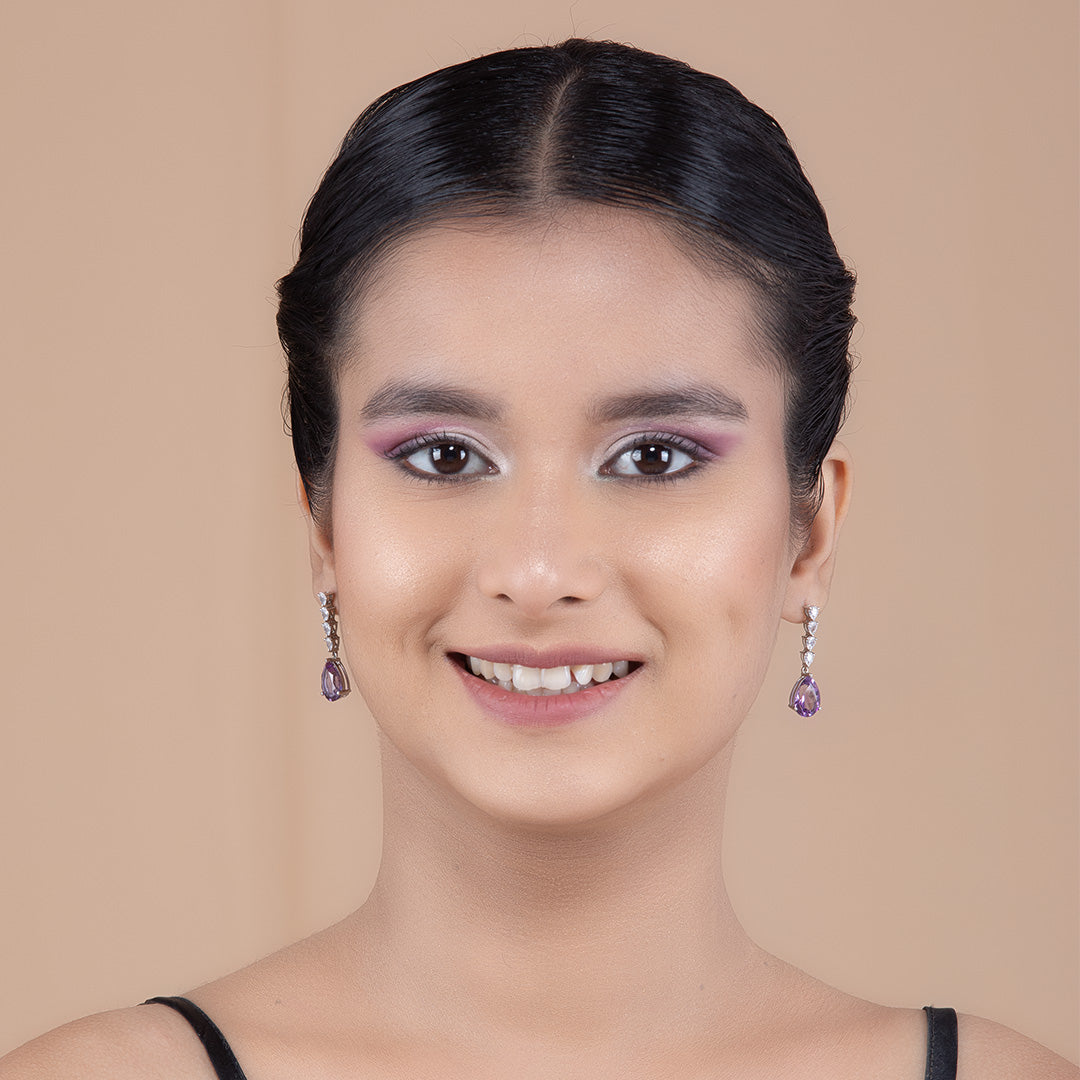 A woman wearing Purple Amethyst Elegance Silver Earrings.