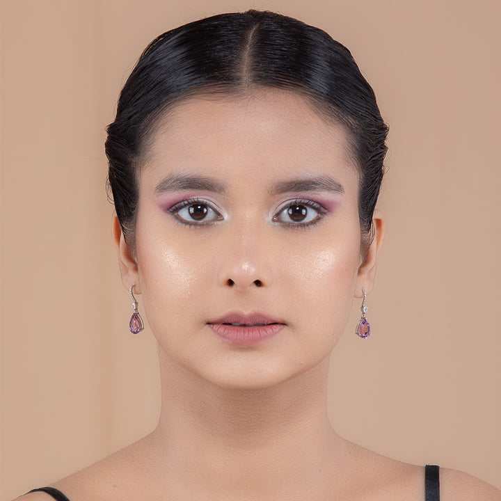 A woman wearing Lilac Amethyst Halo Silver Earrings.