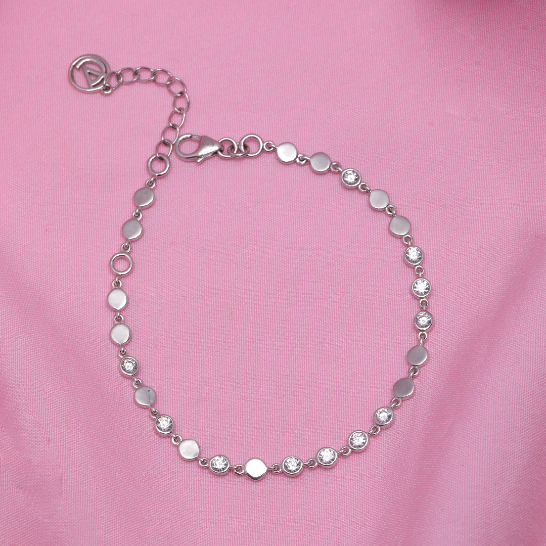 A woman wearing Elegant Silver Finish Tennis Bracelet with Diamond Accents.