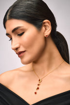 A woman wearing Pendant featuring Red Onyx and Cubic Zirconia.