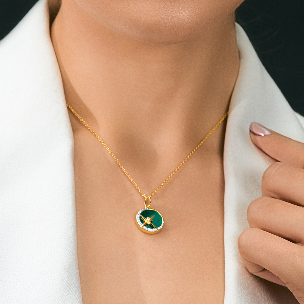 A woman wearing Star Pendant featured with Green Onyx and Cubic Zirconias.