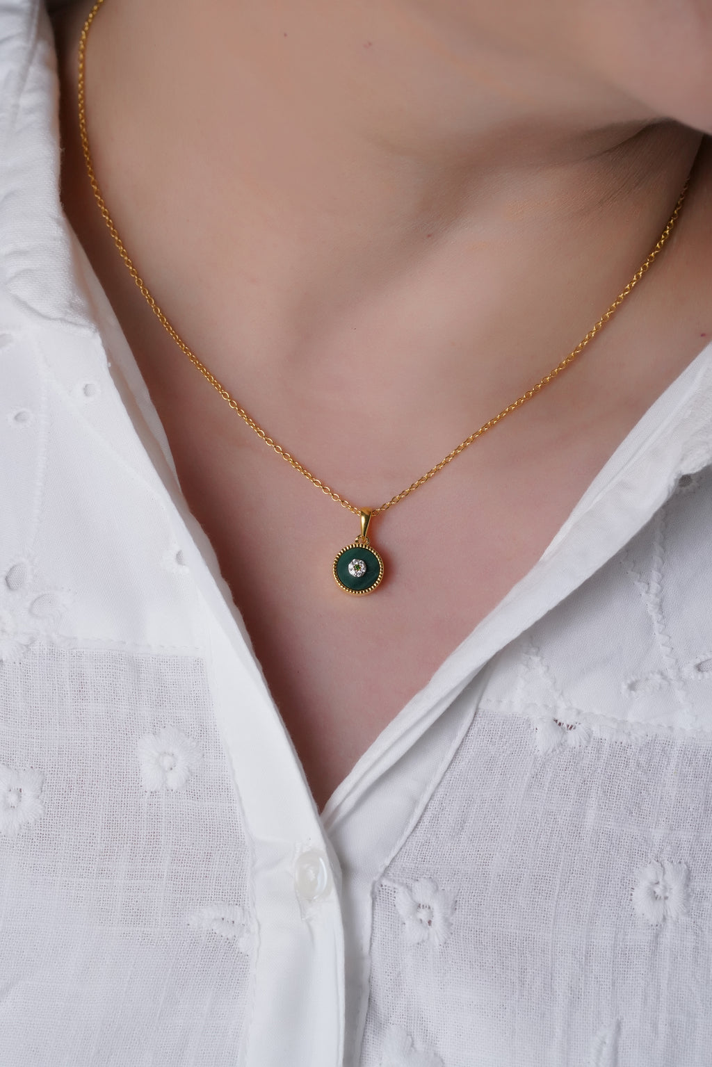  A woman wearing Lush Malchite Splendor Sparkling Cubic Zirconia Pendant with Chain.
