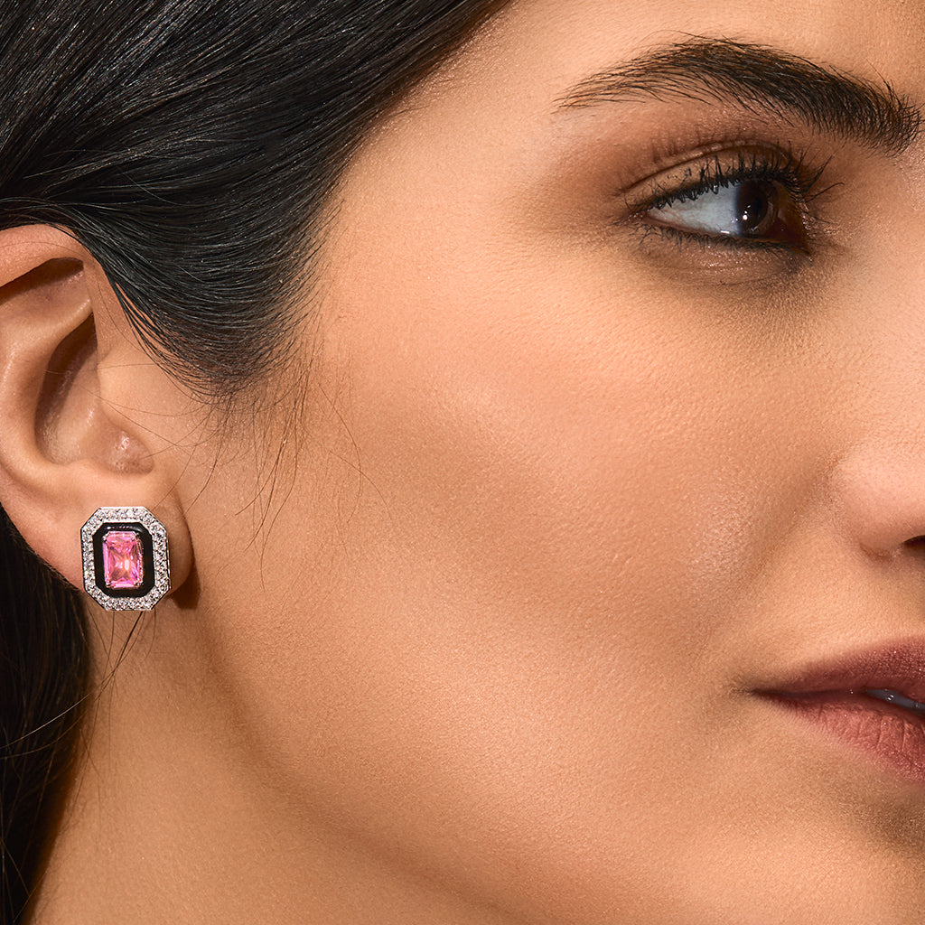 A woman wearing Pink Earrings Adorned with Cubic Zirconia and Ebony Enamel Tops.